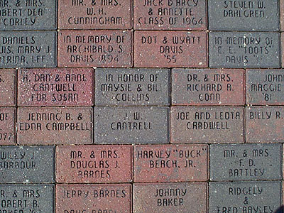 Overhead view of sidewalk bricks with names etched in them